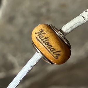Pandora 2012 Pau Amarelo light brown / tan wooden charm Stamped “Nationals”